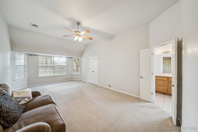 carpeted living room with ceiling fan and lofted ceiling