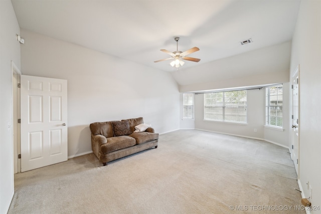 living area featuring light carpet, ceiling fan, and lofted ceiling