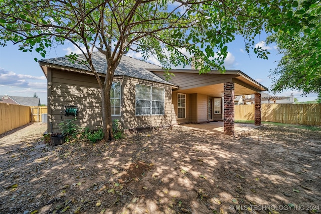 back of house with a patio