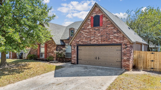 view of front of house featuring a garage and a front yard