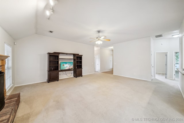 unfurnished living room with ceiling fan, a fireplace, light carpet, and lofted ceiling