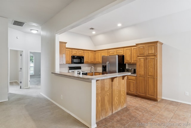 kitchen with white stove, light carpet, stainless steel refrigerator with ice dispenser, kitchen peninsula, and a breakfast bar area