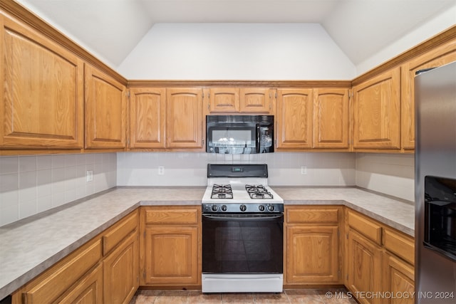 kitchen featuring backsplash, stainless steel fridge with ice dispenser, range with gas stovetop, and vaulted ceiling