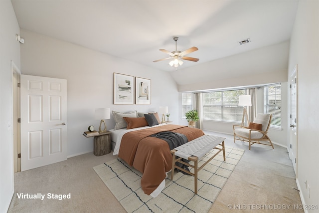 bedroom with light carpet, vaulted ceiling, and ceiling fan