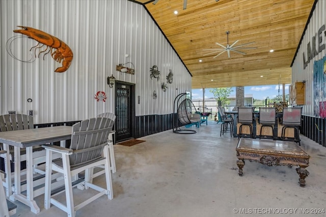 interior space featuring ceiling fan and a bar