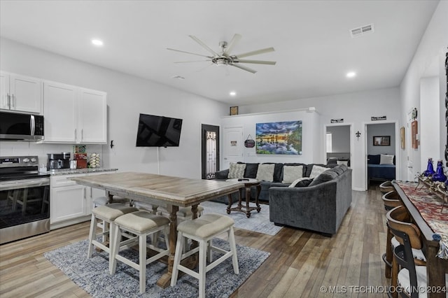 interior space with light hardwood / wood-style floors and ceiling fan