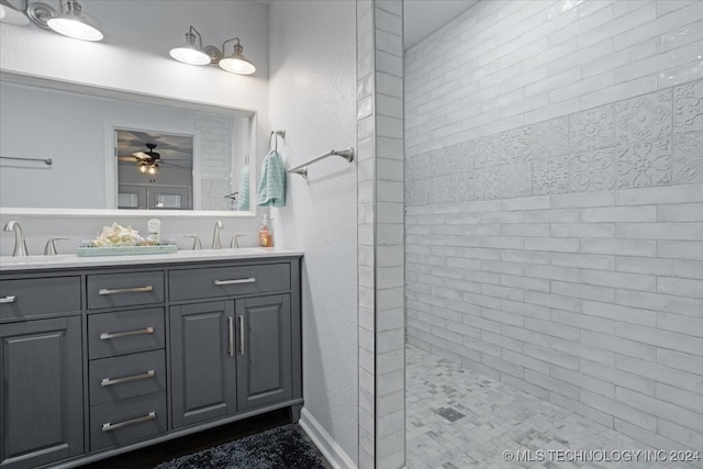 bathroom featuring ceiling fan, vanity, and tiled shower