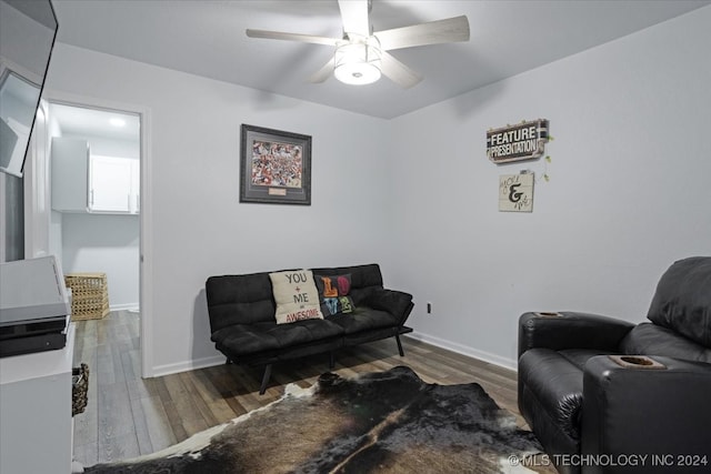 living room with ceiling fan and hardwood / wood-style flooring