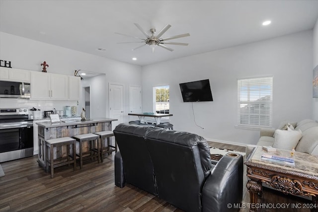 living room featuring dark hardwood / wood-style floors and ceiling fan