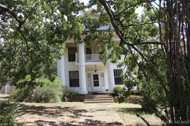 greek revival house with a balcony