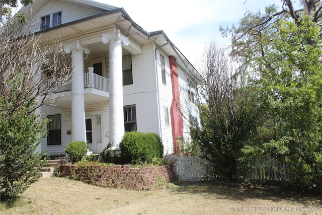 512 N 4th St, Henryetta, OK 74437 - view of side of home featuring a balcony and fence