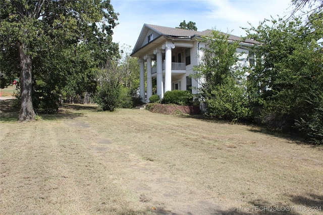 512 N 4th St, Henryetta, OK 74437 - exterior space with a lawn and a balcony