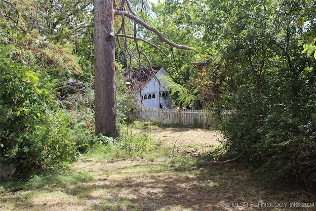 512 N 4th St, Henryetta, OK 74437 - view of yard with a forest view and fence