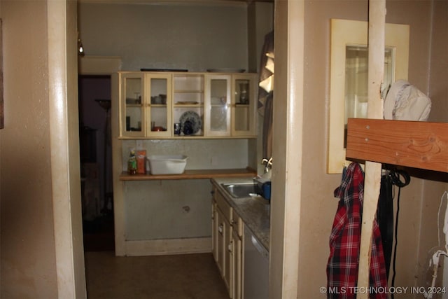 512 N 4th St, Henryetta, OK 74437 - interior space with dishwasher, cream cabinetry, glass insert cabinets, and a sink