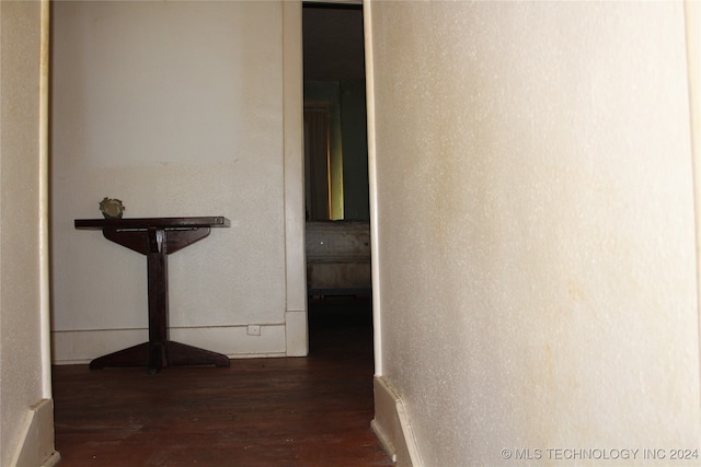 hallway with dark hardwood / wood-style flooring