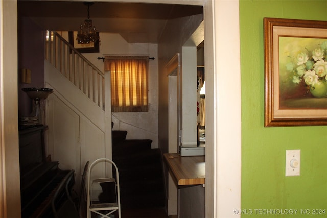 stairs with an inviting chandelier