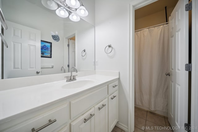 bathroom with tile patterned floors, vanity, and curtained shower