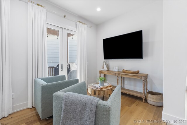 living room featuring hardwood / wood-style flooring and french doors