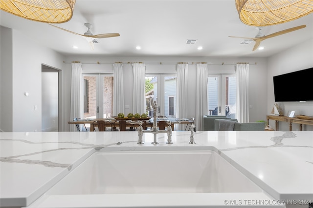 kitchen featuring sink, ceiling fan, and french doors