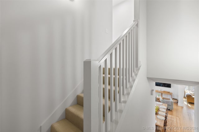 stairway with hardwood / wood-style flooring