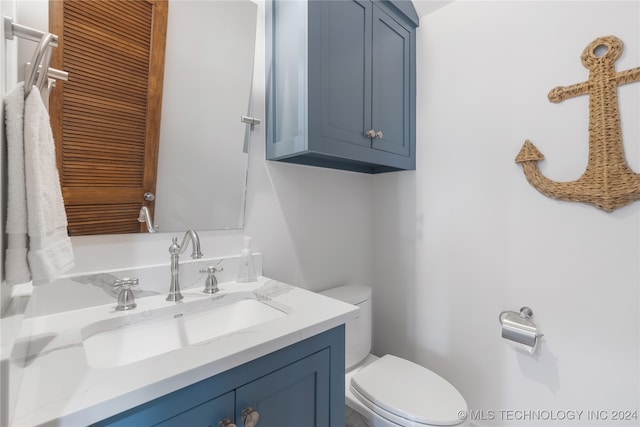 bathroom featuring vanity and toilet