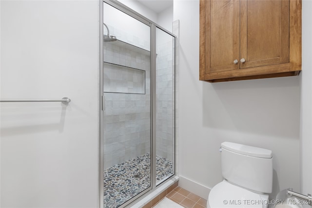 bathroom featuring walk in shower, tile patterned flooring, and toilet