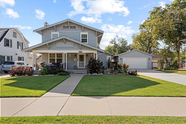 view of front of property with a front lawn, an outdoor structure, a porch, and a garage