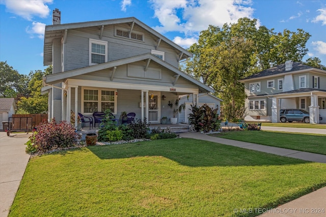 view of front of property featuring covered porch and a front lawn