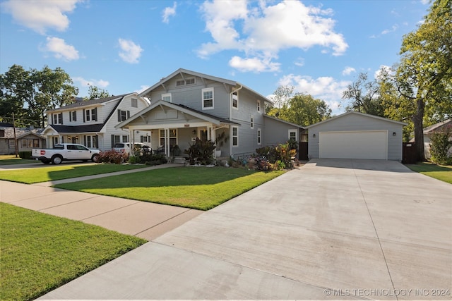 view of front of property featuring an outbuilding, a garage, a porch, and a front yard