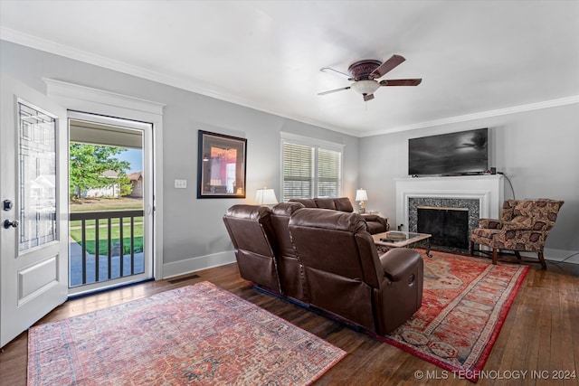 living room featuring ceiling fan, dark hardwood / wood-style floors, and crown molding