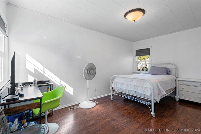 bedroom with dark wood-type flooring