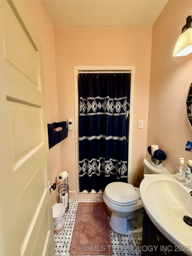 bathroom with toilet, a shower with shower curtain, tile patterned flooring, and vanity