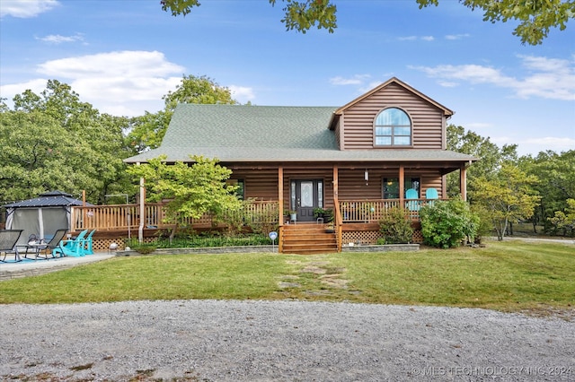 cabin featuring a front yard and a porch