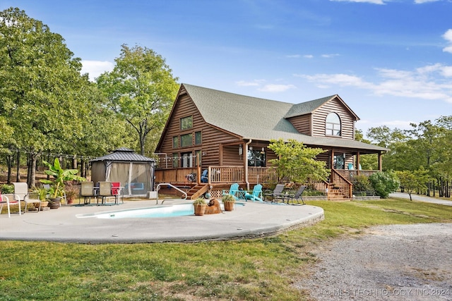 back of property featuring a gazebo, a yard, and a patio