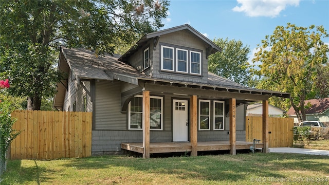 view of front of property with a front yard and covered porch