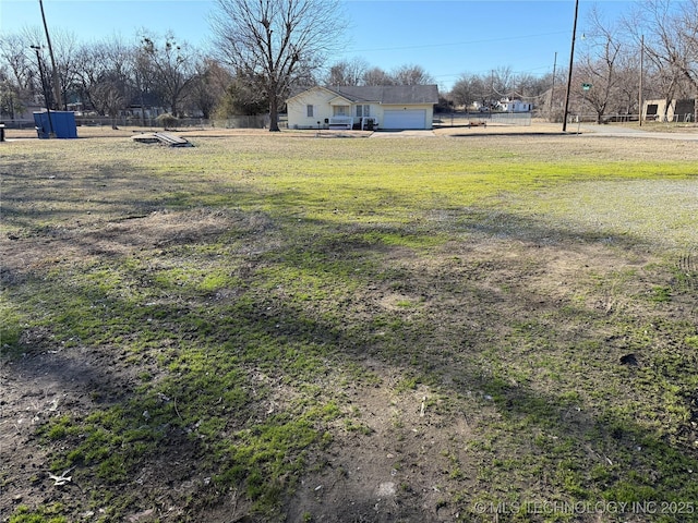 view of yard featuring a garage and fence