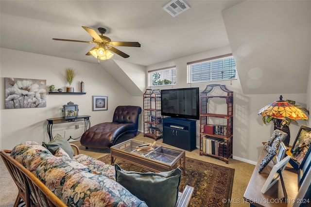 carpeted living room with ceiling fan and lofted ceiling