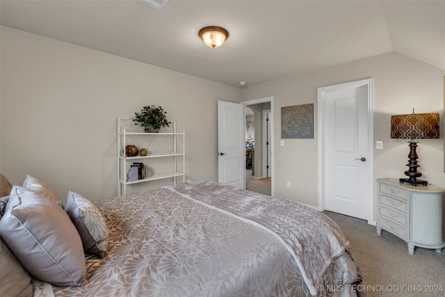 bedroom featuring carpet and lofted ceiling