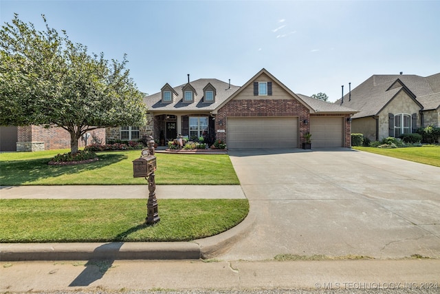 view of front of property featuring a front yard and a garage