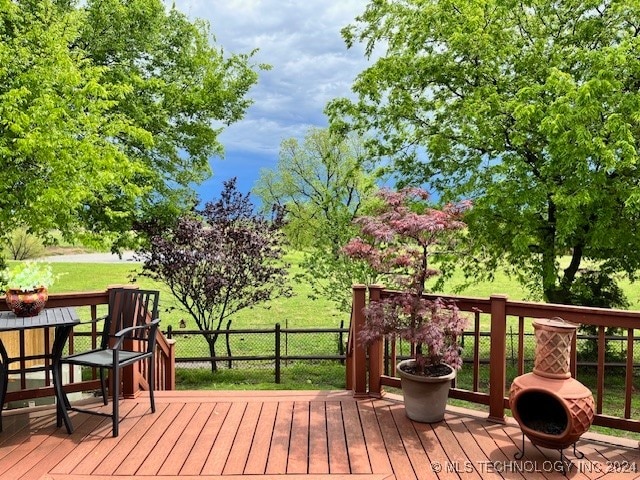 wooden terrace featuring a yard