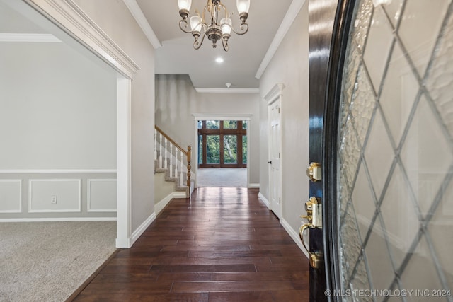 entryway featuring crown molding, a chandelier, and dark hardwood / wood-style flooring