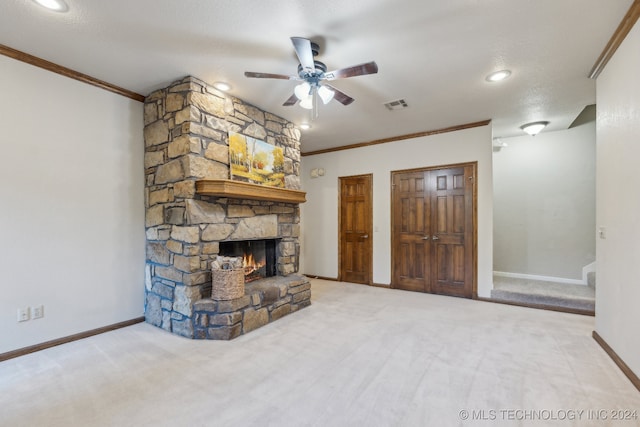 unfurnished living room featuring baseboards, visible vents, a fireplace, ornamental molding, and carpet flooring