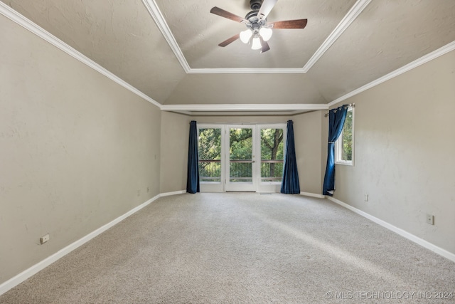 carpeted spare room with ceiling fan, ornamental molding, a textured ceiling, and vaulted ceiling