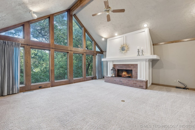 unfurnished living room featuring a fireplace, light colored carpet, a textured ceiling, and ceiling fan