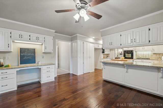 kitchen featuring white cabinets, light stone countertops, and dark hardwood / wood-style floors