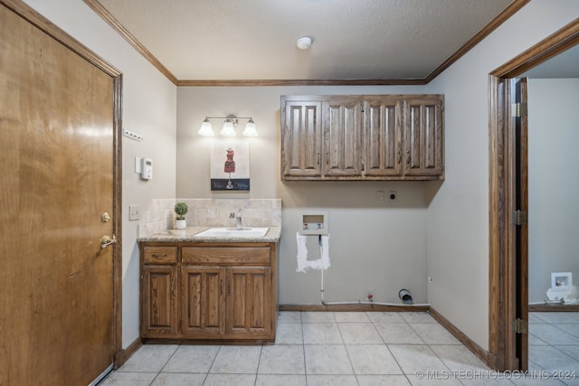 laundry room with a sink, ornamental molding, washer hookup, electric dryer hookup, and hookup for a gas dryer