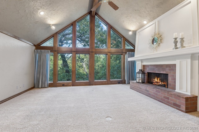 unfurnished living room with carpet, beamed ceiling, high vaulted ceiling, a textured ceiling, and a brick fireplace