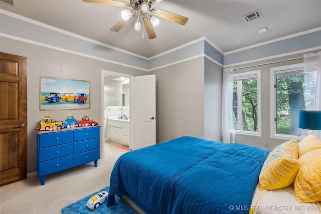 bedroom with visible vents, ensuite bath, ceiling fan, ornamental molding, and light colored carpet