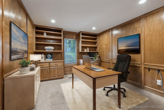 home office with wooden walls, recessed lighting, and light colored carpet