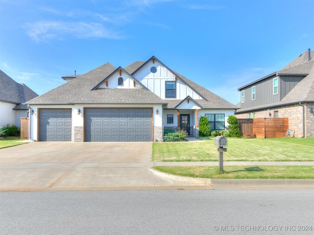 view of front of property with a front yard and a garage